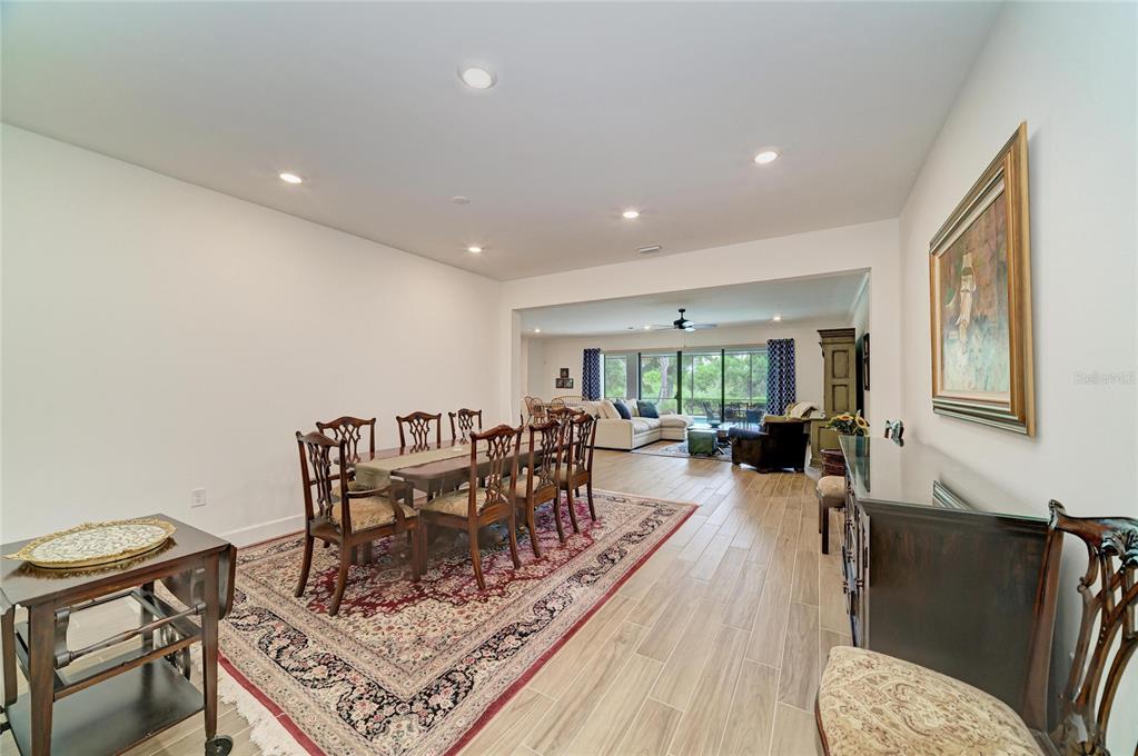 16341 Hidden Oak Loop Lakewood Ranch, FL 34211 - Photo 6 of 76 a view of a dining room with furniture window and wooden floor