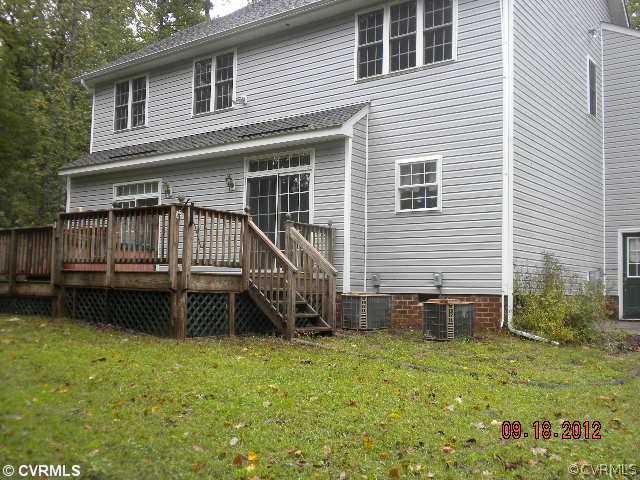 4315 Broad St Road Gum Spring, VA 23065 - Photo 2 of 10 a backyard of a house with a garden and deck