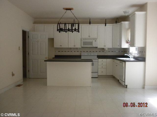 4315 Broad St Road Gum Spring, VA 23065 - Photo 4 of 10 a kitchen with stainless steel appliances a sink a stove a refrigerator and cabinets