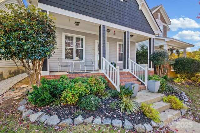 a front view of a house with a yard outdoor seating and garden
