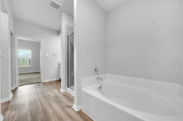 a bathroom with a bathtub and shower