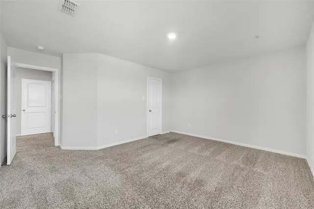 a view of an empty room with windows