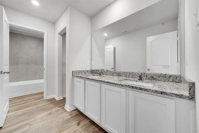 a bathroom with a toilet sink and shower
