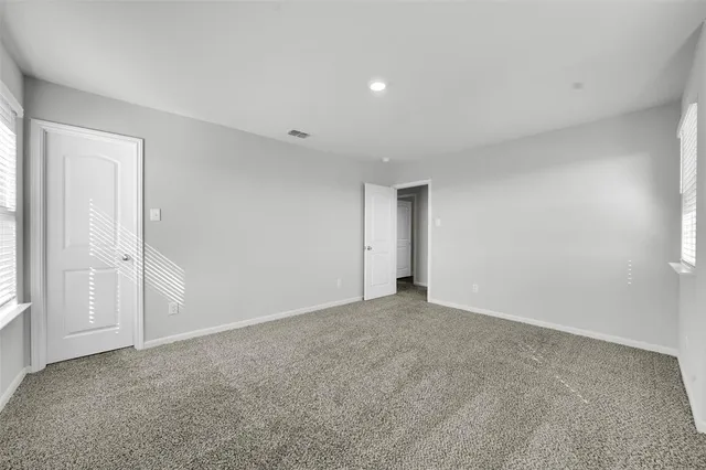 a view of an empty room and closet area