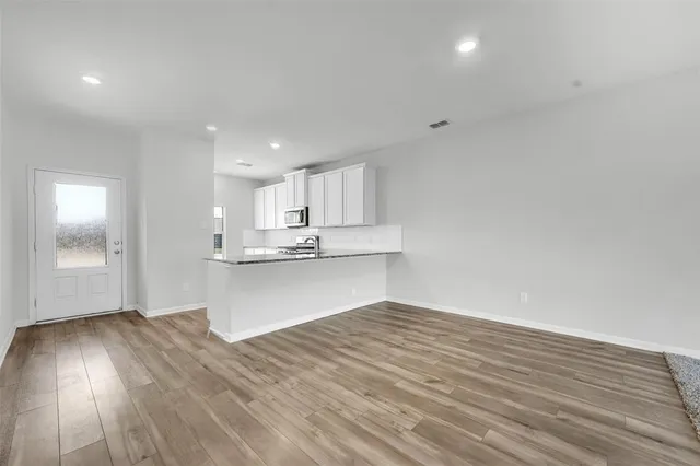 a view of kitchen with wooden floor and window