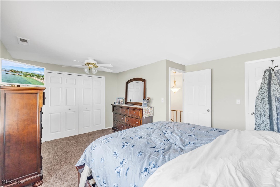 6486 State Road, Unit C5 Parma, OH 44134 - Photo 19 of 27 Bedroom featuring carpet flooring, a closet, and a ceiling fan