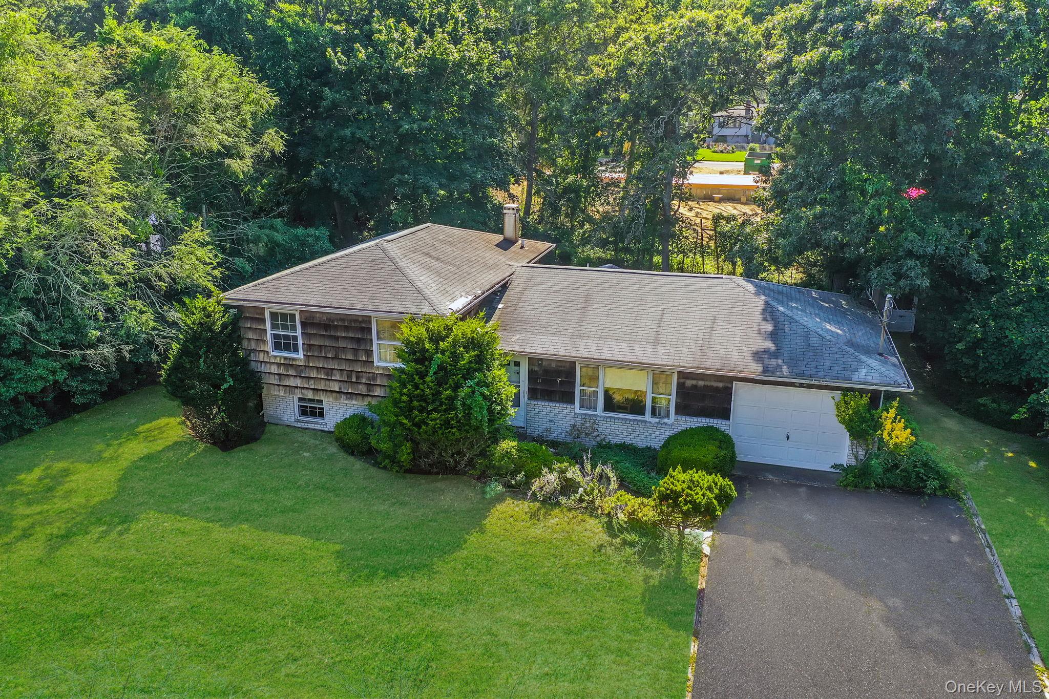 a aerial view of a house next to a yard