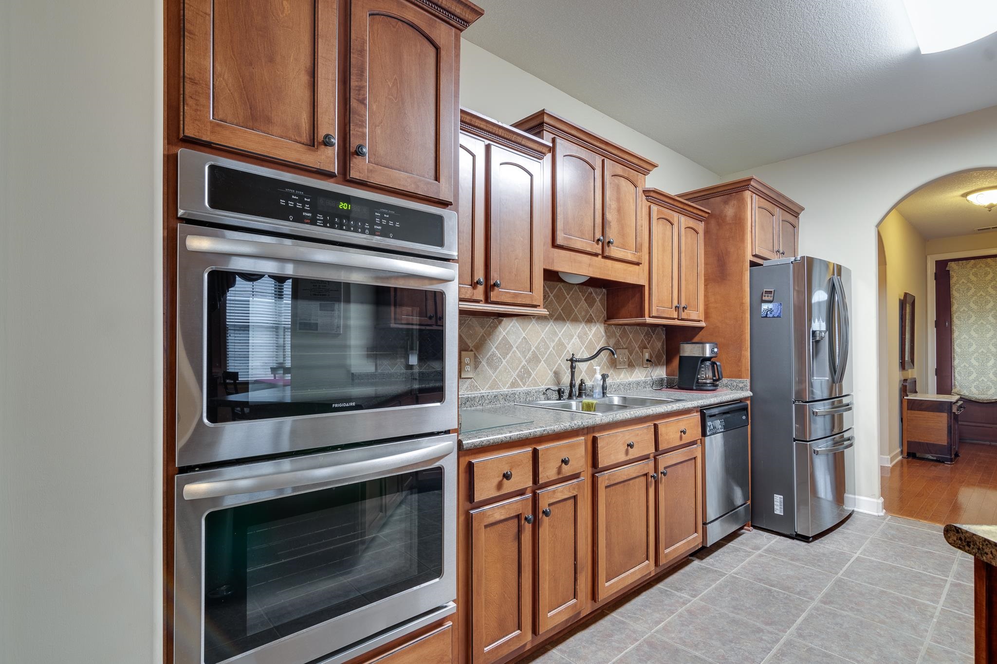 5350 Evergreen Road Lakeland, TN 38002 - Photo 13 of 24 Kitchen featuring light wood-type flooring, backsplash, stainless steel appliances, and sink