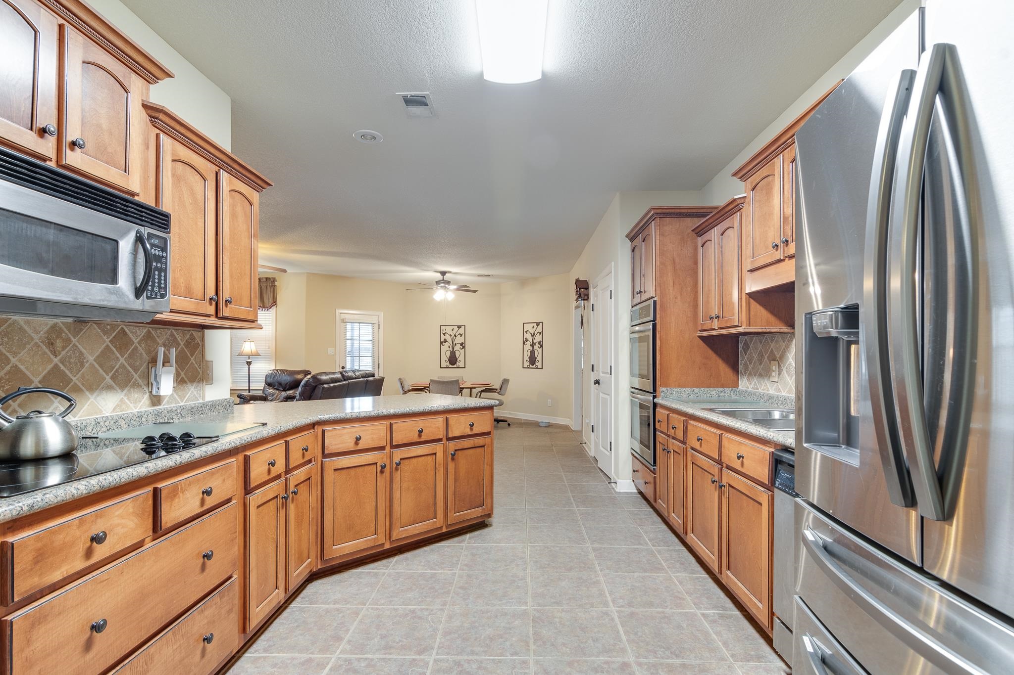 5350 Evergreen Road Lakeland, TN 38002 - Photo 14 of 24 Kitchen featuring light tile patterned flooring, stainless steel appliances, tasteful backsplash, and ceiling fan