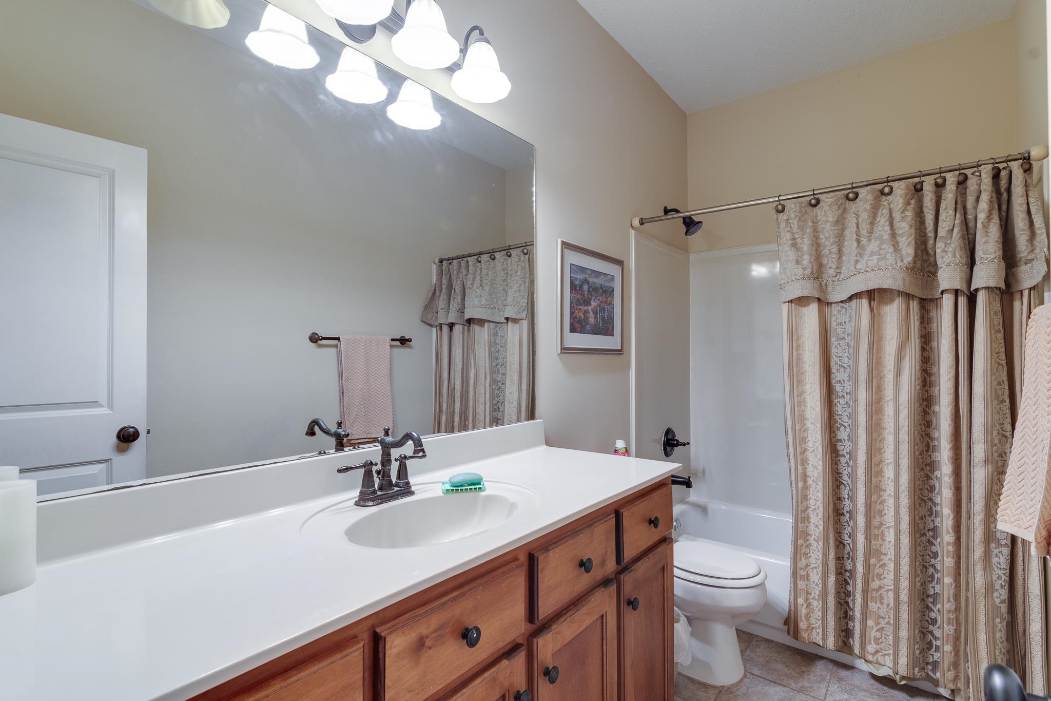 5350 Evergreen Road Lakeland, TN 38002 - Photo 20 of 24 Full bathroom featuring toilet, shower / bath combination with curtain, vanity, and tile patterned floors