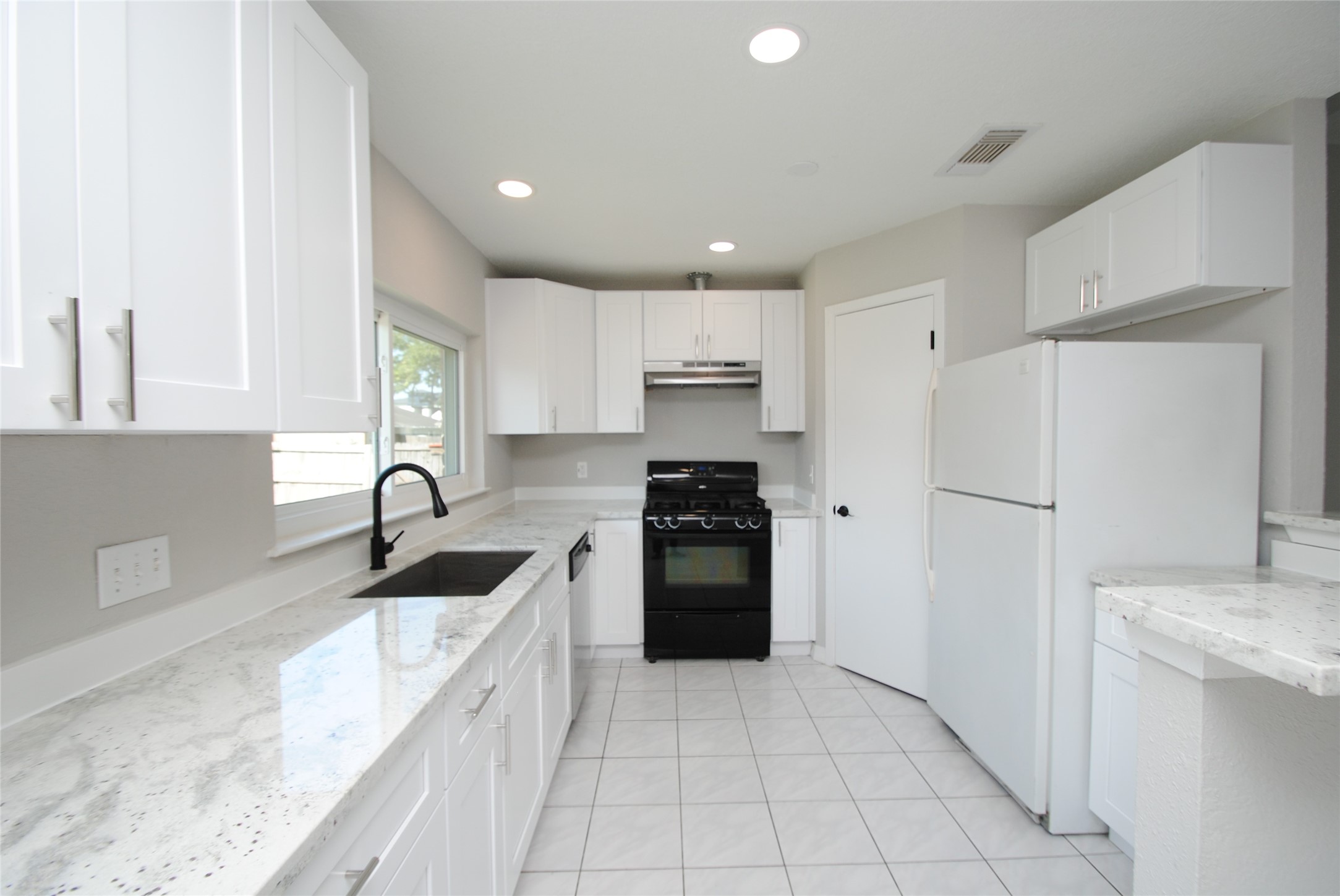 22831 John Rolfe Lane Katy, TX 77449 - Photo 12 of 34 a kitchen with a refrigerator sink and cabinets
