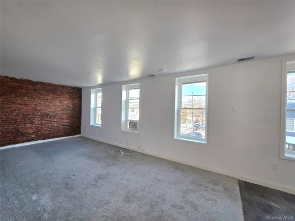 a view of an empty room with windows