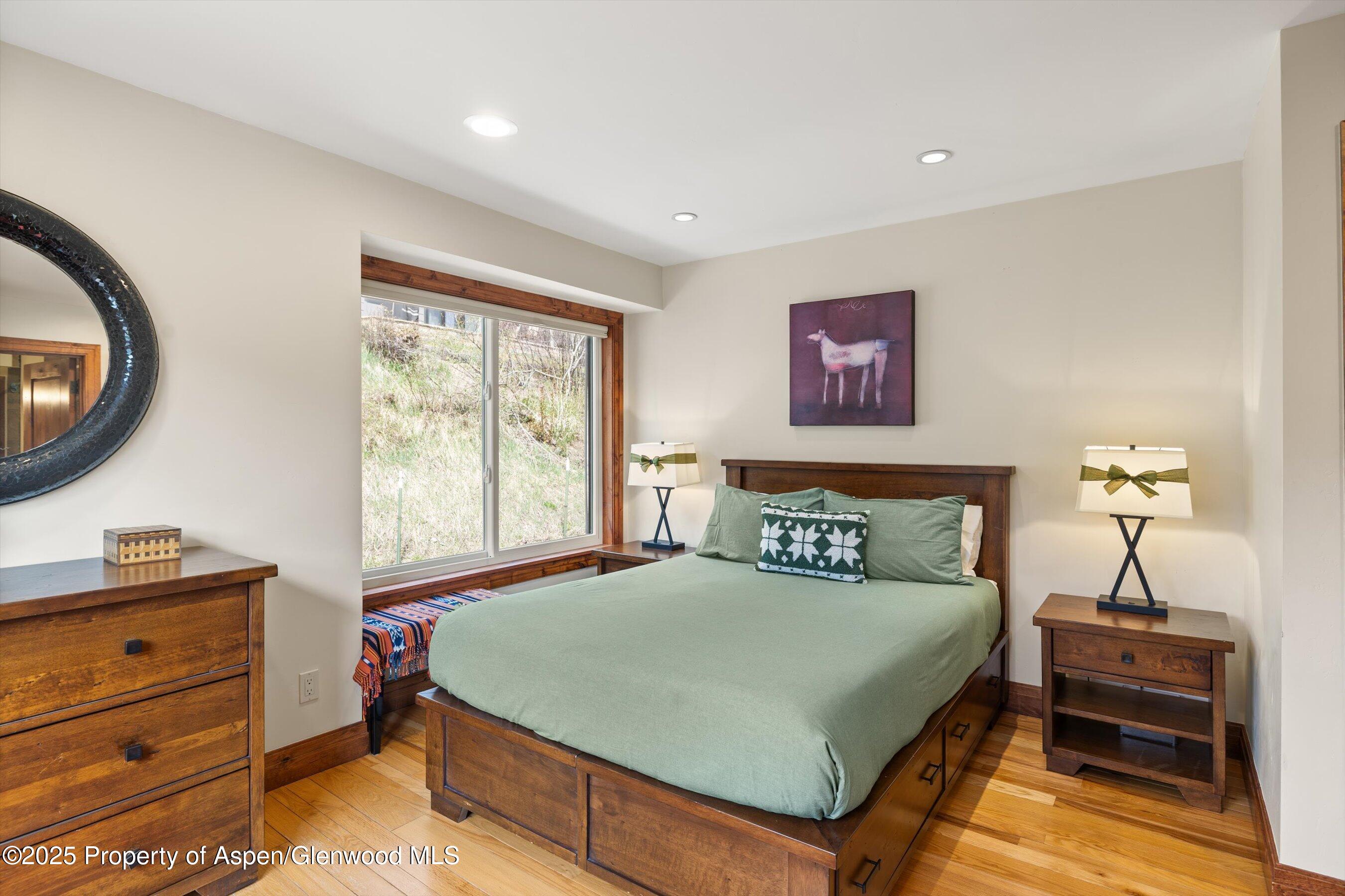 35 Lower Woodbridge Road, Unit W 184 Snowmass Village, CO 81615 - Photo 12 of 32 a bedroom with a bed and a window