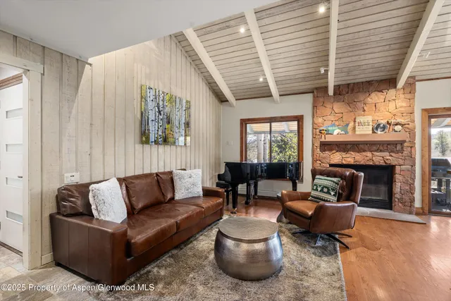 a living room with furniture wooden floor and a fireplace
