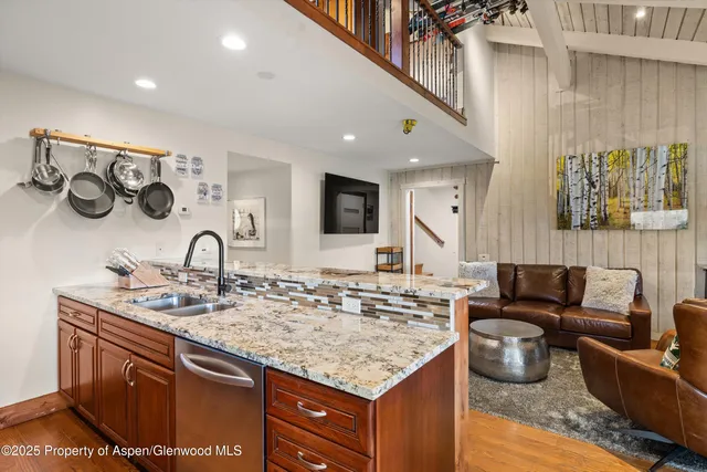 a kitchen with a sink and a stove with living room