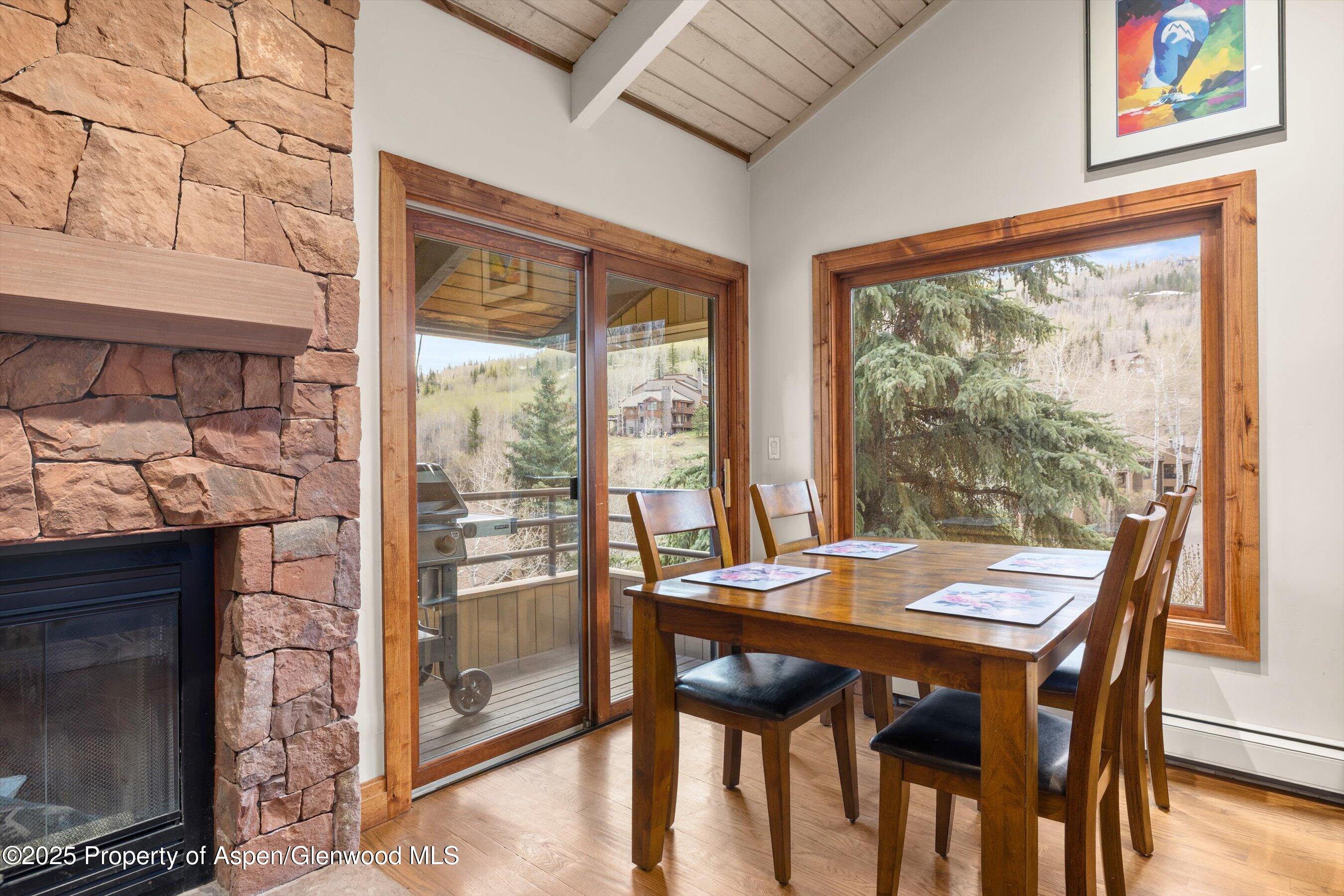 35 Lower Woodbridge Road, Unit W 184 Snowmass Village, CO 81615 - Photo 10 of 32 a view of a dining room with furniture window and wooden floor