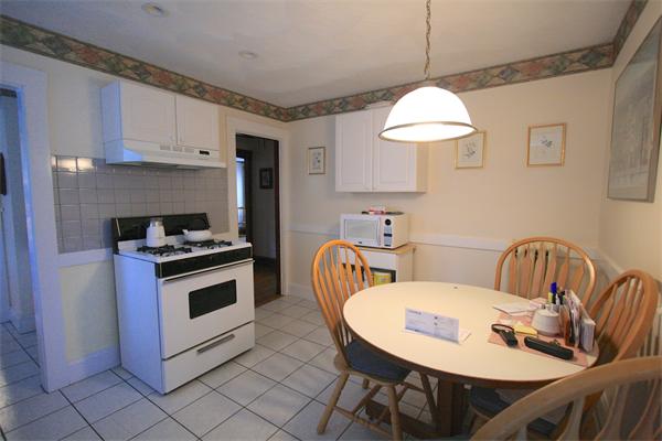 8-10 Robbins Road Arlington, MA 02476 - Photo 10 of 10 a kitchen with stainless steel appliances a stove a table and chairs