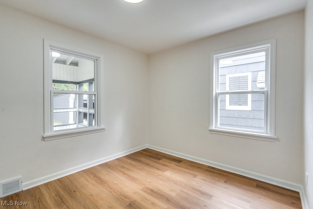 4237 Verona Road Cleveland, OH 44121 - Photo 16 of 41 Empty room featuring light wood-type flooring and healthy amount of natural light