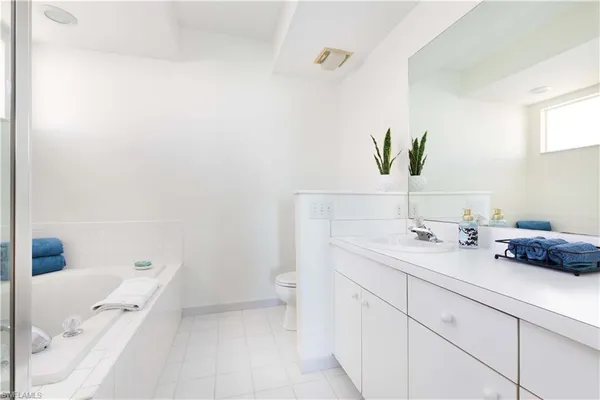 a bathroom with a sink a vanity and toilet