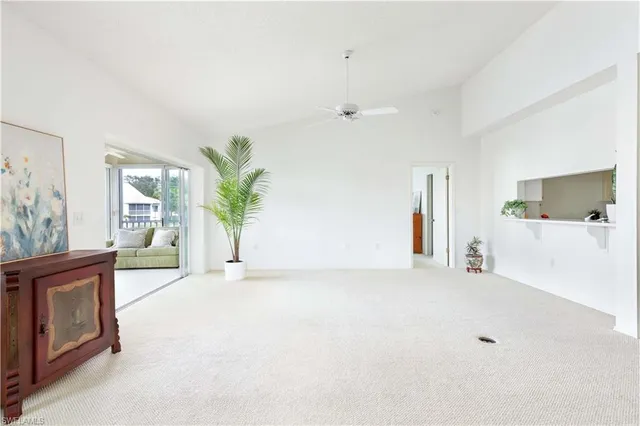 a view of an empty room with a window and a flat screen tv