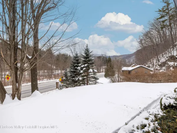 a view of a house with a yard covered in snow