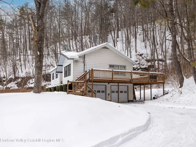 a view of a house with a yard covered in snow