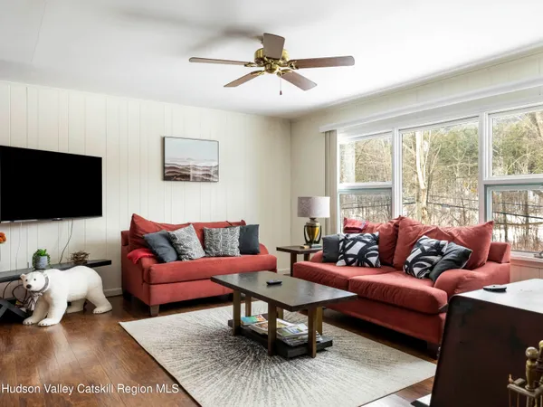 a kitchen with stainless steel appliances granite countertop a refrigerator a stove top oven a sink dishwasher and white cabinets with wooden floor