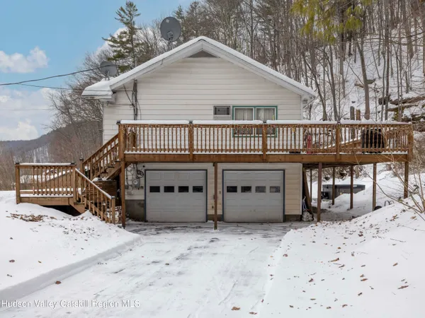 a view of a house with a wooden fence
