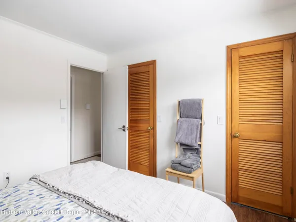 a view of a room with wooden floor and furniture
