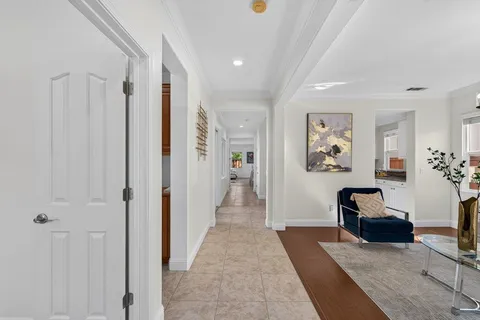 a view of a hallway with workspace and a window