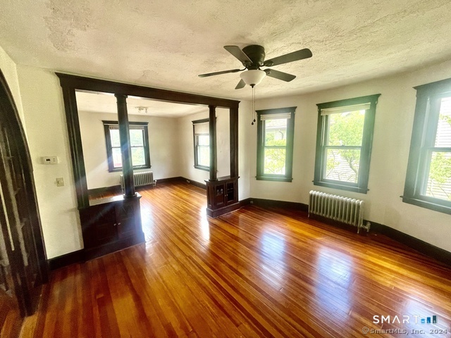 64 East Pearl Street Torrington, CT 06790 - Photo 1 of 6 a view of empty room with wooden floor and fan