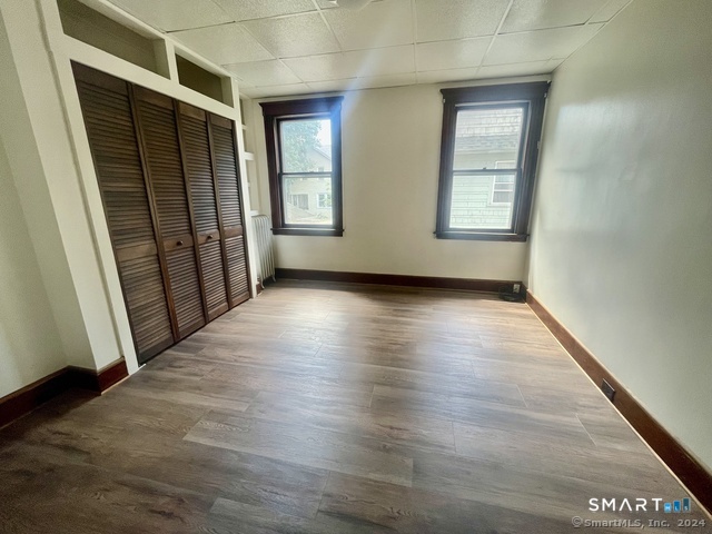 64 East Pearl Street Torrington, CT 06790 - Photo 4 of 6 an empty room with wooden floor and windows