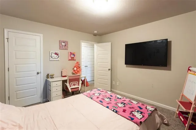 a bedroom with a bed and flat screen tv