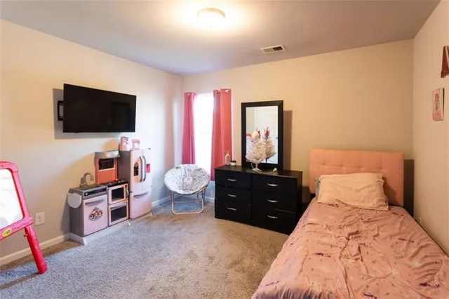 a bedroom with a bed and a table