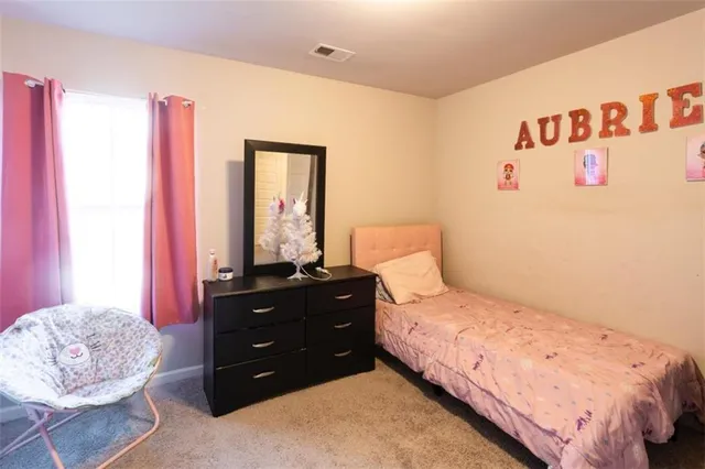 a bathroom with a granite countertop toilet sink and mirror