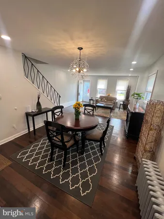 a dining room with furniture a rug and a chandelier