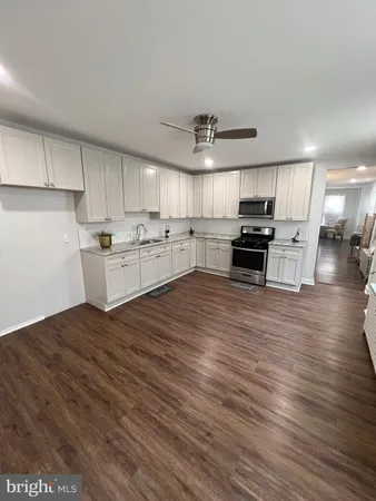 a kitchen with stainless steel appliances a refrigerator sink and microwave