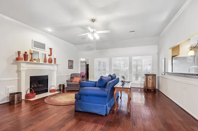 a living room with furniture fireplace and wooden floor