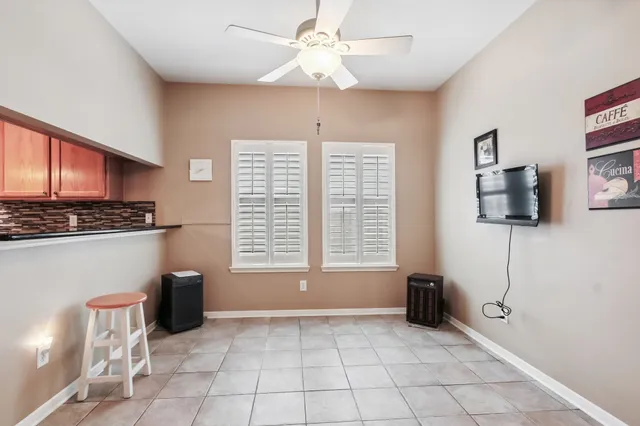 a view of kitchen with furniture flat screen tv and window
