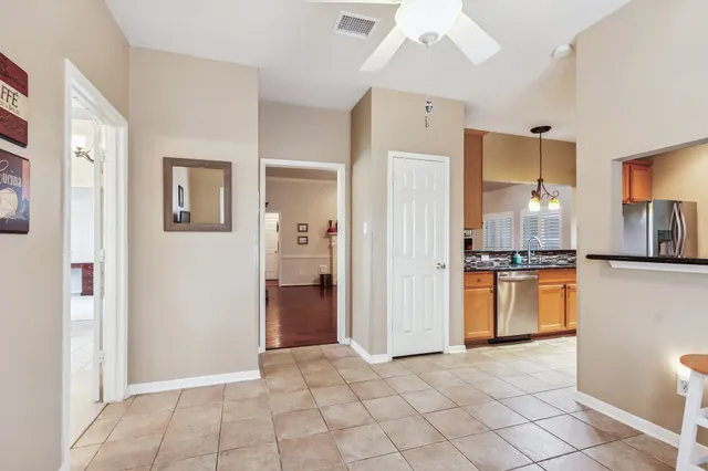 a view of a kitchen with a refrigerator and a stove top oven