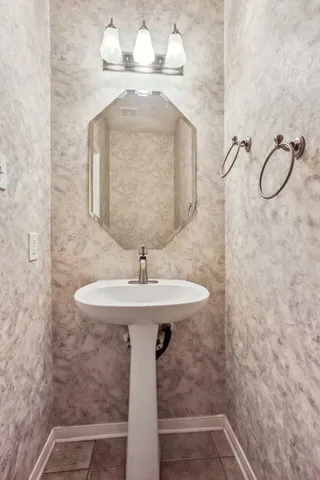 a bathroom with a sink a mirror and vanity