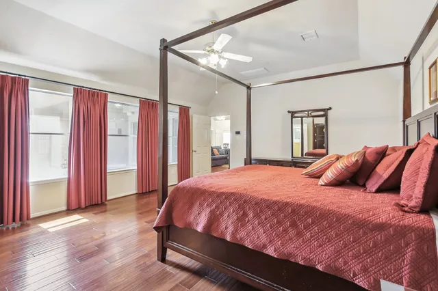 a bedroom with a large bed and a chandelier