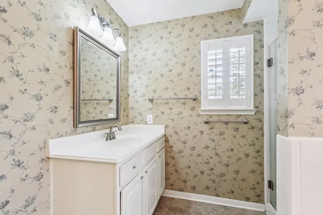 a bathroom with a sink a mirror and a shower