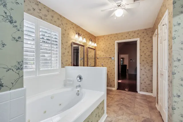 a bathroom with a bathtub and a shower