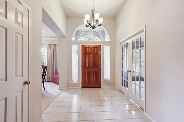 a view of a hallway with windows and stairs