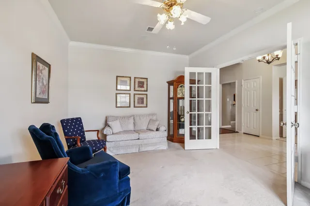 a living room with furniture and a chandelier
