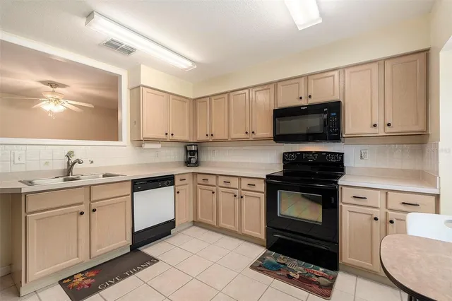 a kitchen with a sink stove and microwave