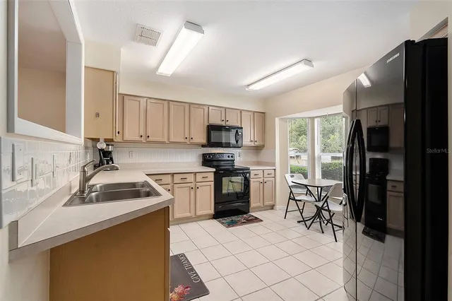 a kitchen with a sink a stove and refrigerator