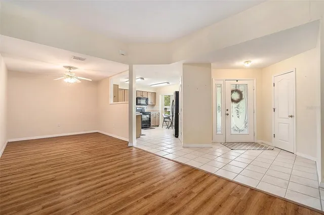 a view of an empty room with wooden floor