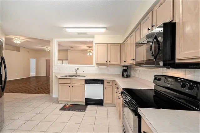 a kitchen with a sink cabinets and stainless steel appliances